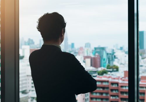 Back, thinking and businessman in office, buildings and planning for investment, trader and glass.